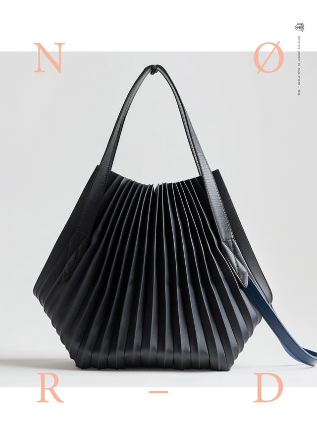 “Minimalist black pleated shoulder bag with soft architectural form and elongated strap, showcasing modern luxury, Scandinavian design, and refined craftsmanship.” · TheGrandHeavyBold